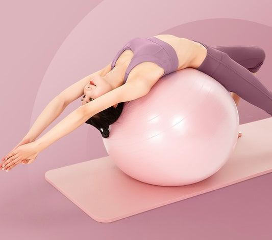 A lady using 55cm pink pvc yoga ball